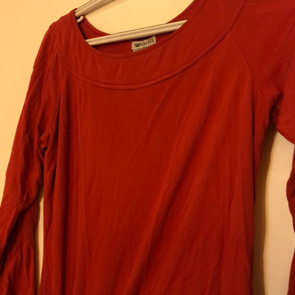 Pink mid length sleeve sheer top.